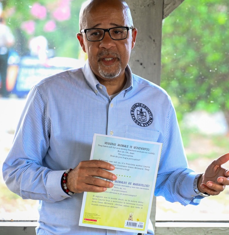 Dr. North Reads a book at a Summer Reading event.