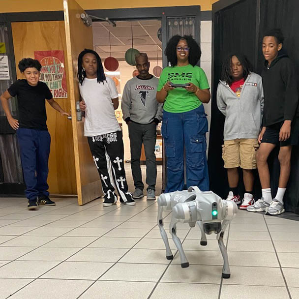 SMS students work with a dog robot