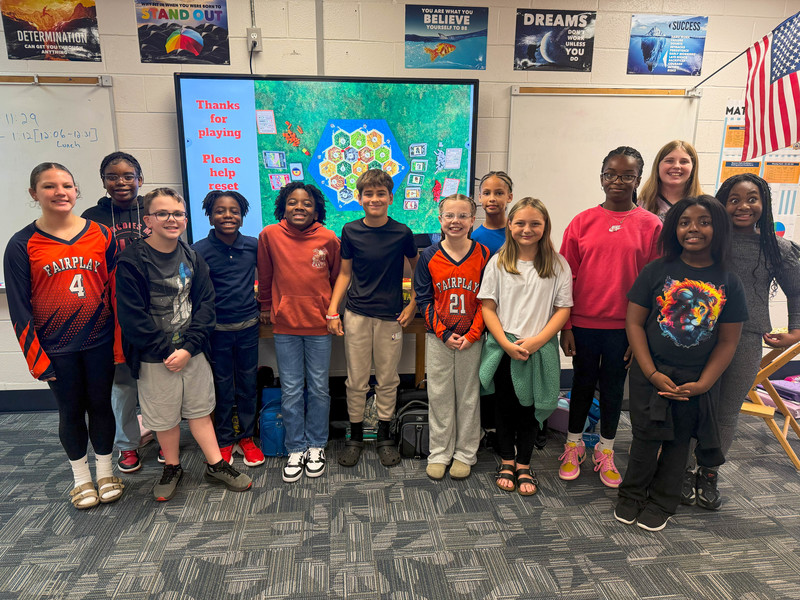 FMS class photo with Catan on a whiteboard.