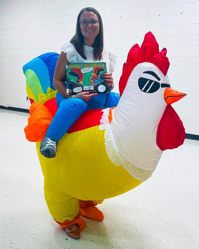 MLES Principal Lisa Huey holds up a book for Georgia Reads Day.