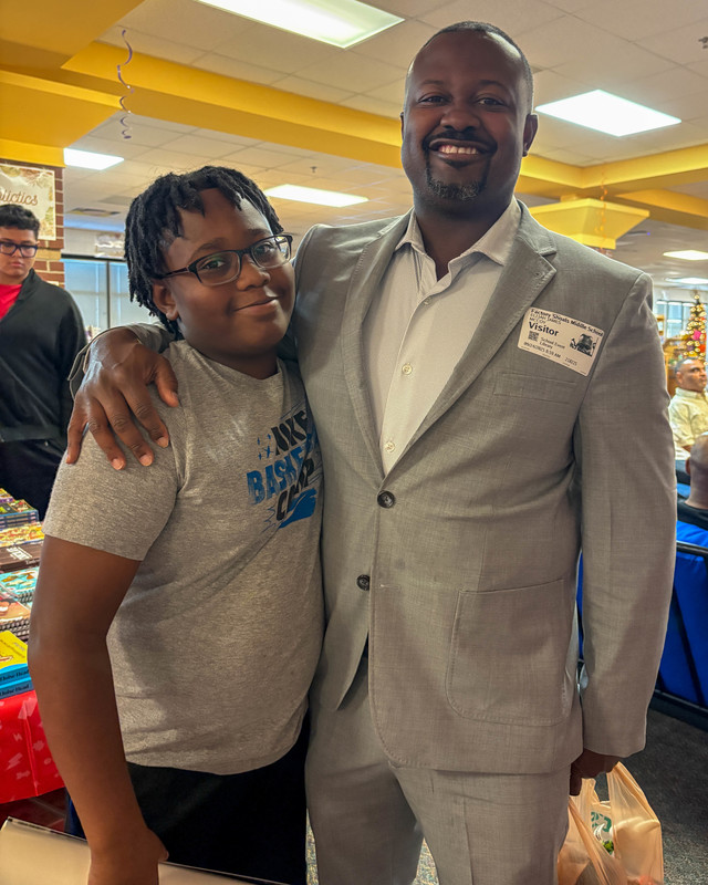 A FSMS student with his dad during Doughnuts with Dads