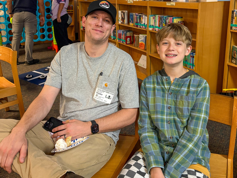 A FSMS student with his dad during Doughnuts with Dads