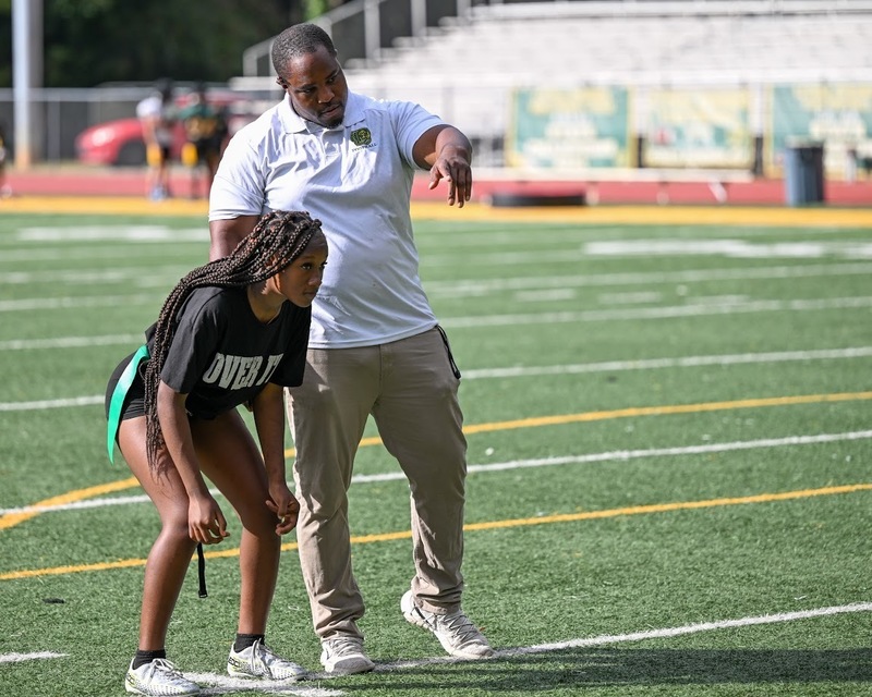 LSHS head flag football coach Darius Owens works with a player during practice.