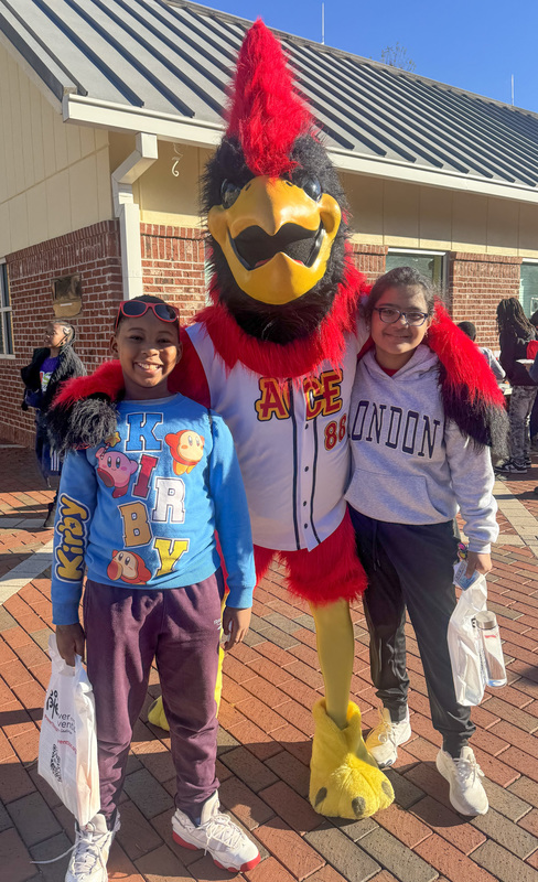 AWES students with a mascot