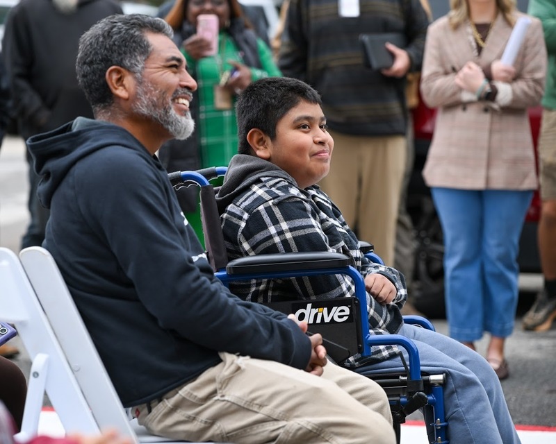 Max Pachecho Ruiz and his father Eustasio smile during the ribbon-cutting for Max Crossing.