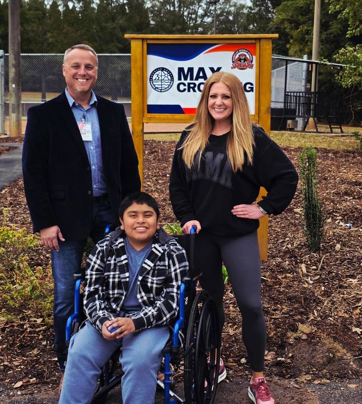 Chad and Adrienne Griffin with Max Pachecho Ruiz at the ribbon-cutting for Max Crossing.