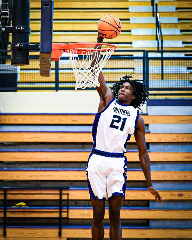 A Chapel Hill boys player makes a dunk during practice.