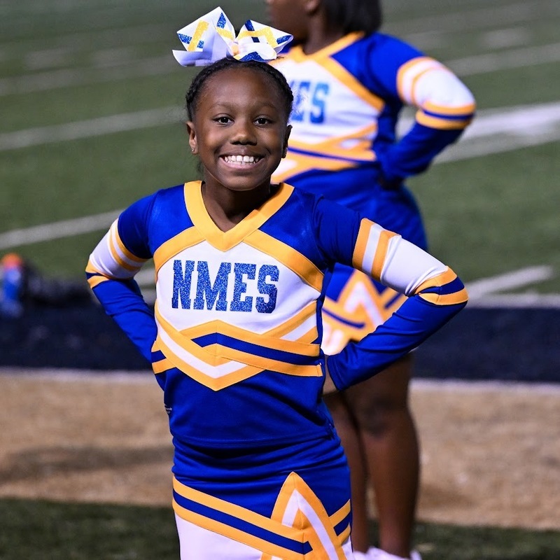 A NMES cheerleader smiles during the Turkey Bowl.