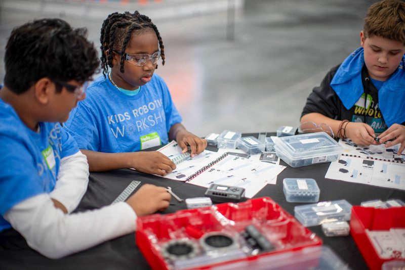Students work on a robot at the Robotics Workshop