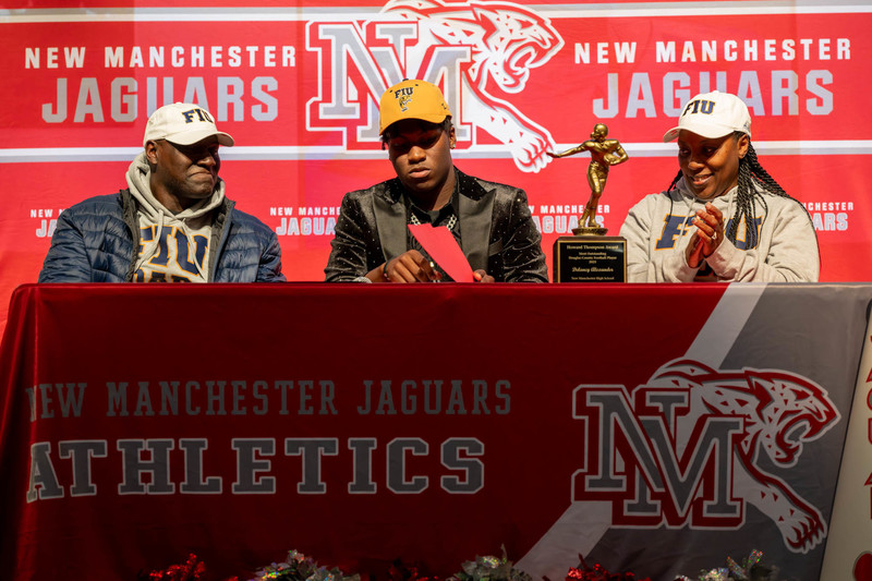 Delancy Alexander signs with FIU as his parents look on.