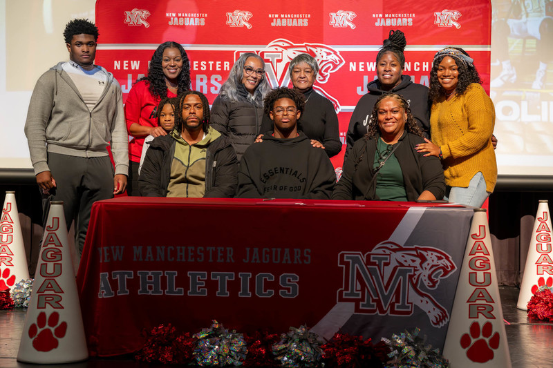 Colin Bussey and his family as he signs with Charlotte