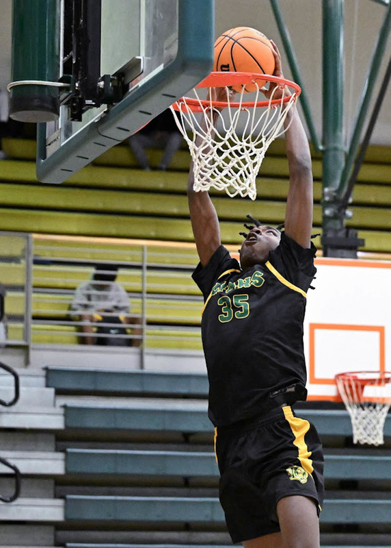 A LSHS boys basketball player dunks the ball.