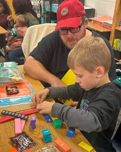 A father and son participate in ASES Math Mania