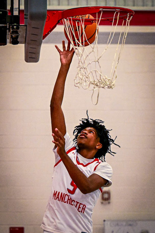 A New Manchester boys player shoots a layup.