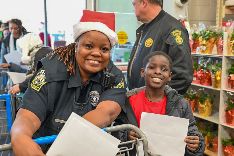 A SRO poses with a student at DCSS Police Shop with a  Cop.