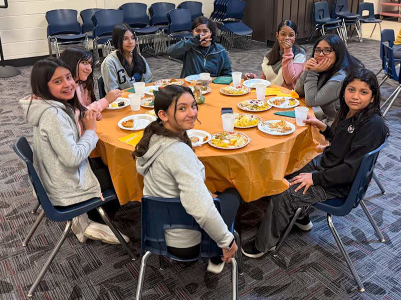 Newcomer Center students enjoy a traditional American Thanksgiving meal.