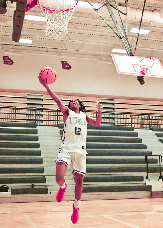 A DCHS boys basketball player makes a layup during practice.