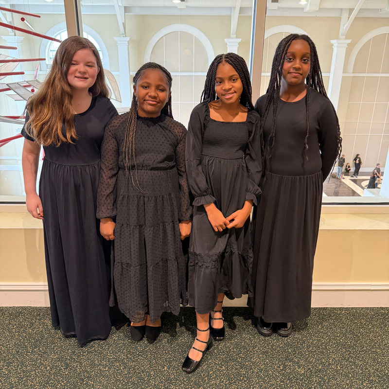 Four Honor Chorus students from Douglas County pose for a group photo.