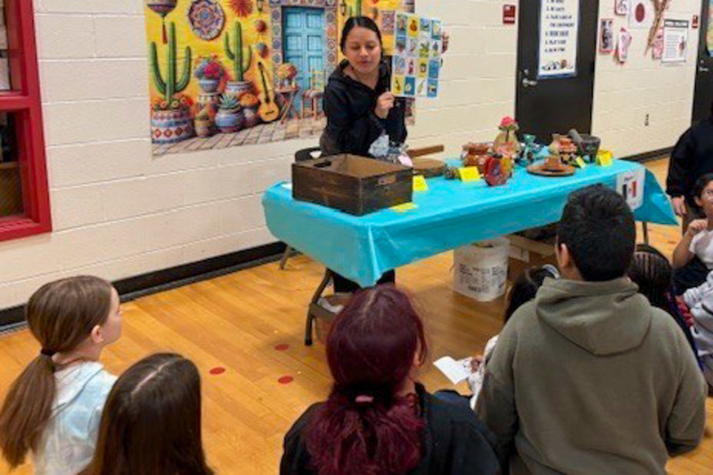 Winston staff member Vanessa Colin leads an activity during the Passport Around the World event.