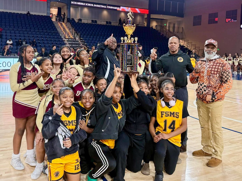 Stewart's eighth grade boys basketball team with the championship trophy.