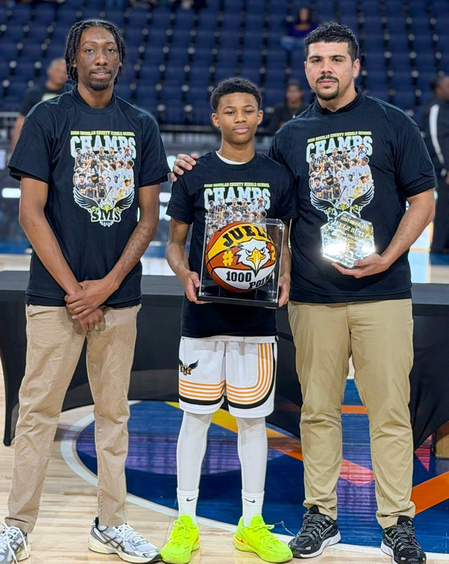 Stewart’s Juelz Butler reached 1,000-plus career points during the championship game last Saturday. He is pictured with coaches and a special basketball. 