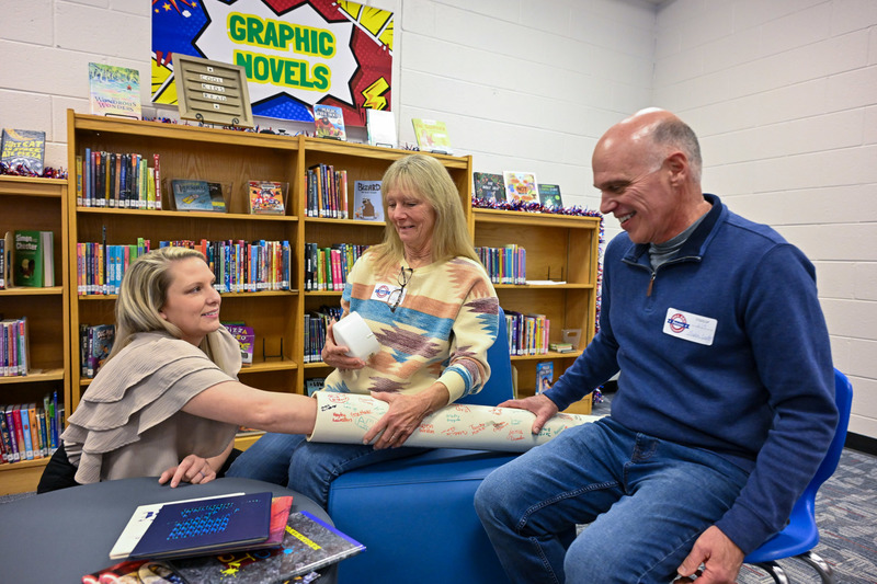 Amber Sauls Cardell, a member of the Bill Arp fifth-grade class of 1999-2000, and two former BAES teachers - Suse McKeeman and Robert Blevins - open a 26-year old time capsule.