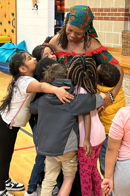 Winston Elementary students hug a performer during a special Black History Month program.