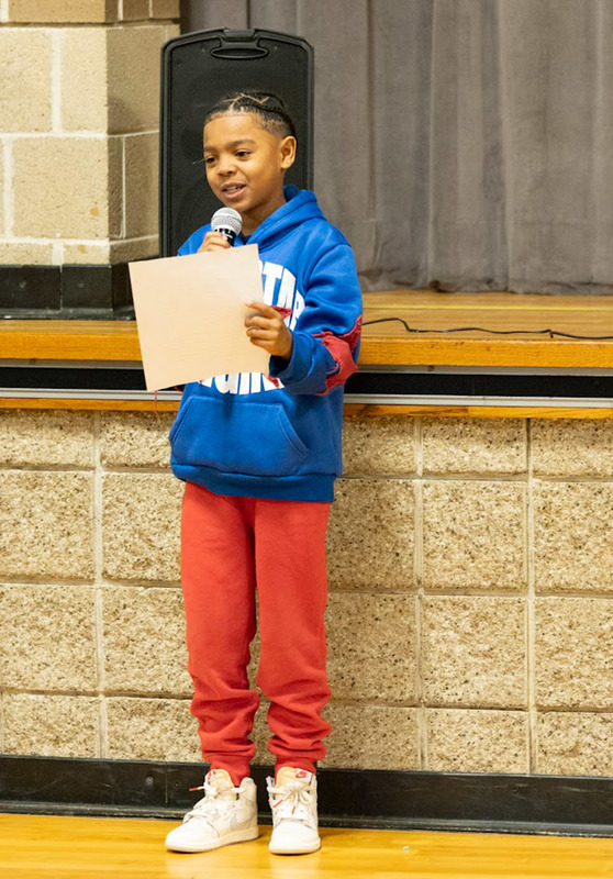 An Arbor Station Elementary student reads during an presentation for Black History Month.