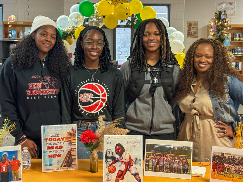 NMHS girls basketball players with Factory Shoals Middle Media Specialist Katrina Barnett.