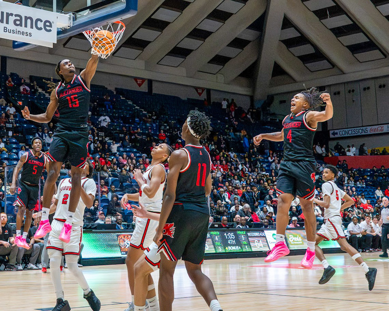 Christian Moore dunks the ball as MVP Pops Dunson jumps in excitement to put the exclamation point on the Cougars state championship.