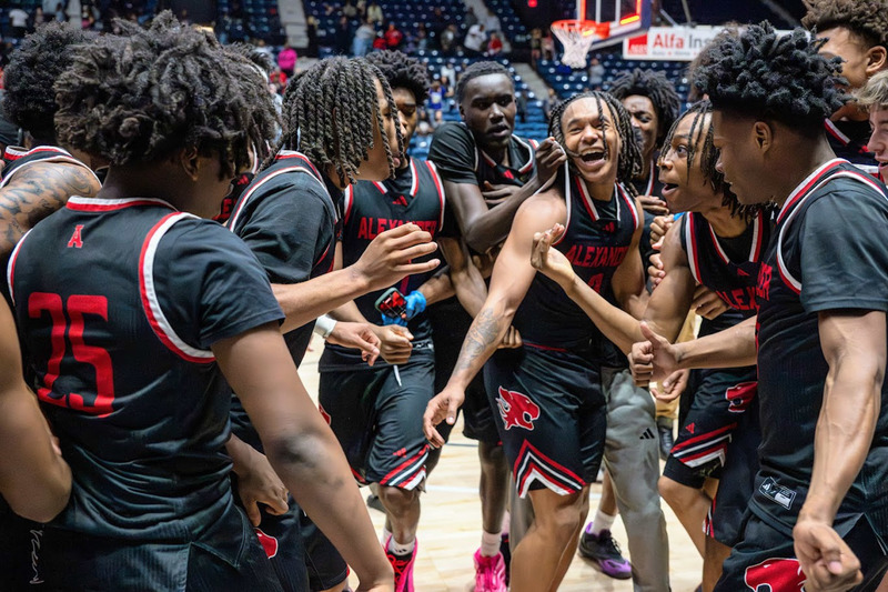 The Cougars celebrate on the floor of the Macon Coliseum after their championship.