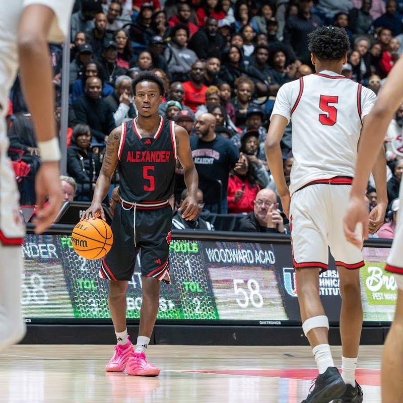 Jayden Crawford dribbles the ball up court during the championship game with Woodward.