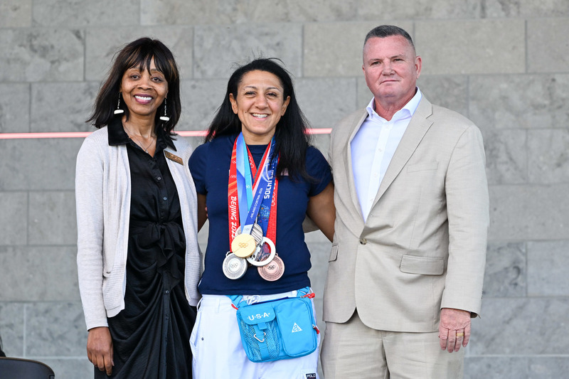 Board of Education Chair Glenn Easterwood and Vice Chair Michelle Simmons pose with Elana Meyers Taylor.