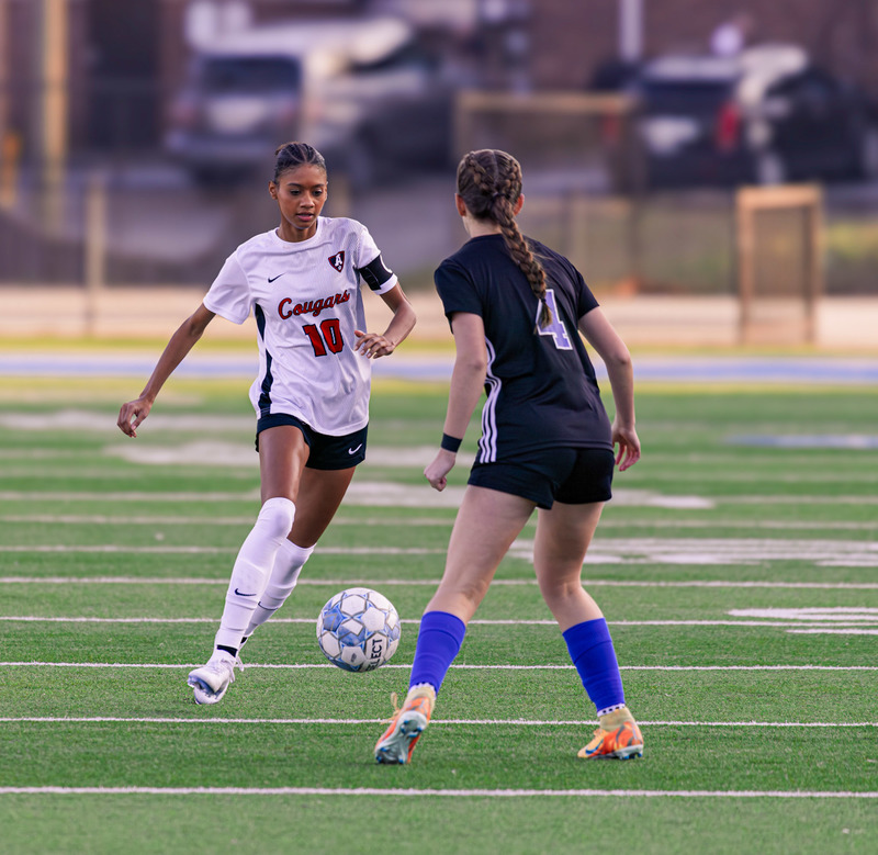 Alexander's  Brielle Delgado  kicks the soccer ball along the sidelines during a recent game.