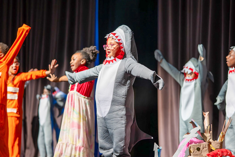 A Sweetwater Elementary student in a shark costume performs as part of Finding Nemo: Kids.