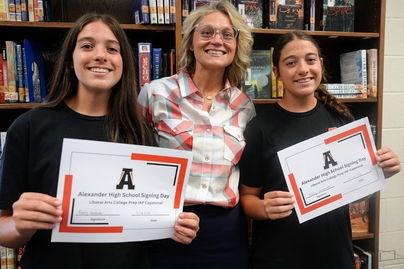 Assistant Superintendent Chelsie Goodman poses with daughters Penny and Ginny at Mason Creek Middle's Magnet Signing Day event.