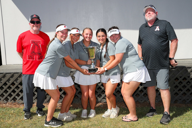 Alexander girls golf team members with their county championship trophy.