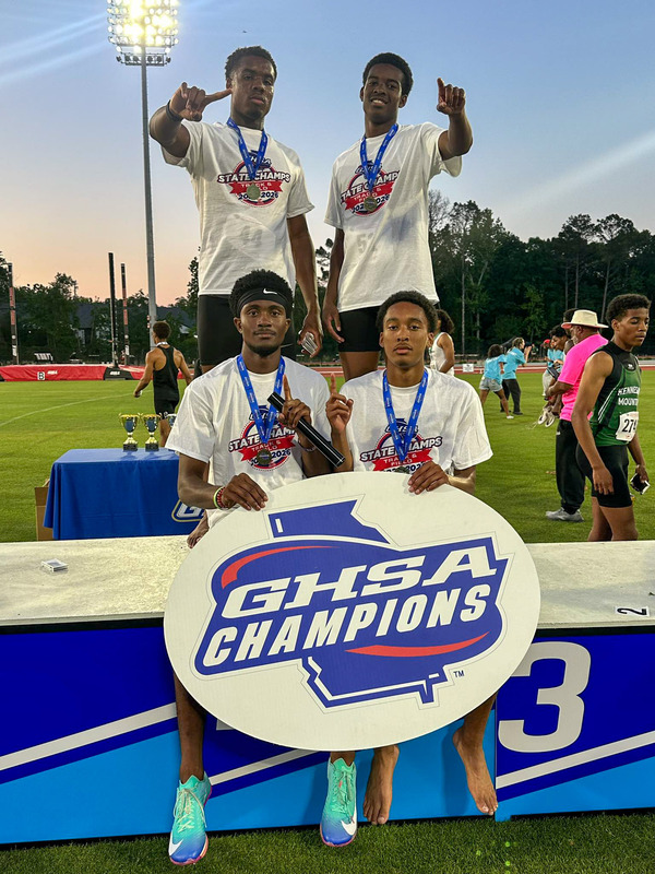 The Alexander boys 4x400 relay team of ﻿Richard Wilson, Landyn Buchanan, Cayden Guidry and Justyn McKenzie hold up the GHSA Champions sign.