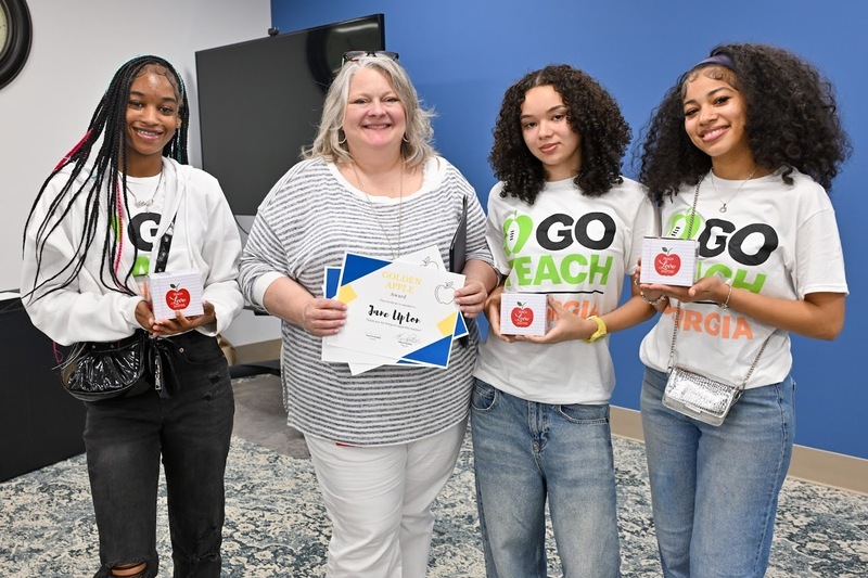 Douglas County High teacher Jane Upton with the students who gave her the Golden Apple Award.