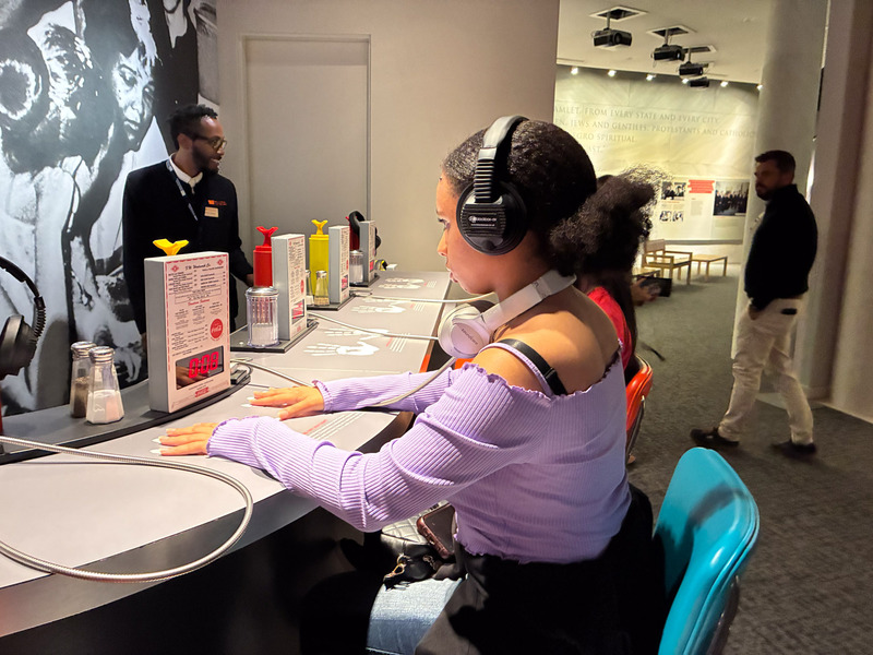 A Douglas County High student takes part in an interactive exhibit at a museum.