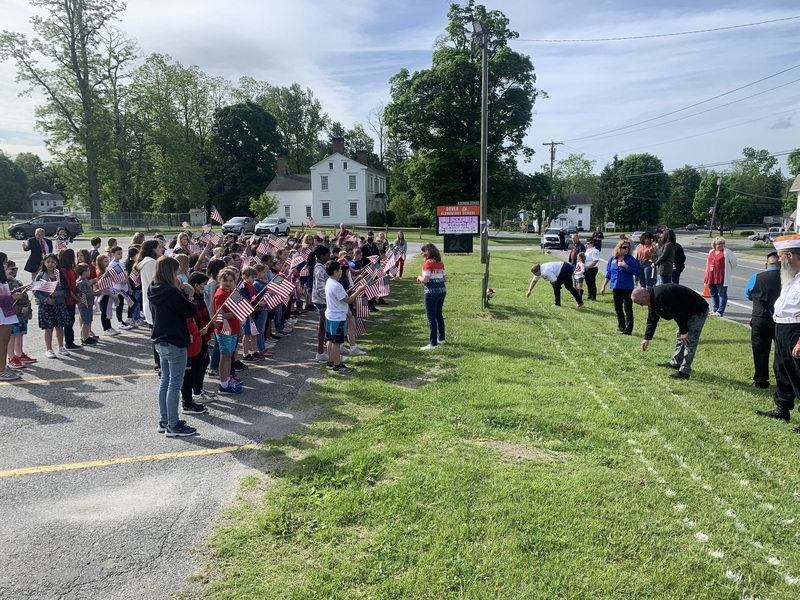 Students with flags for memorial day event