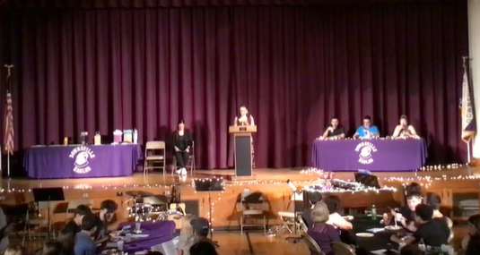image from recording of an awards banquet