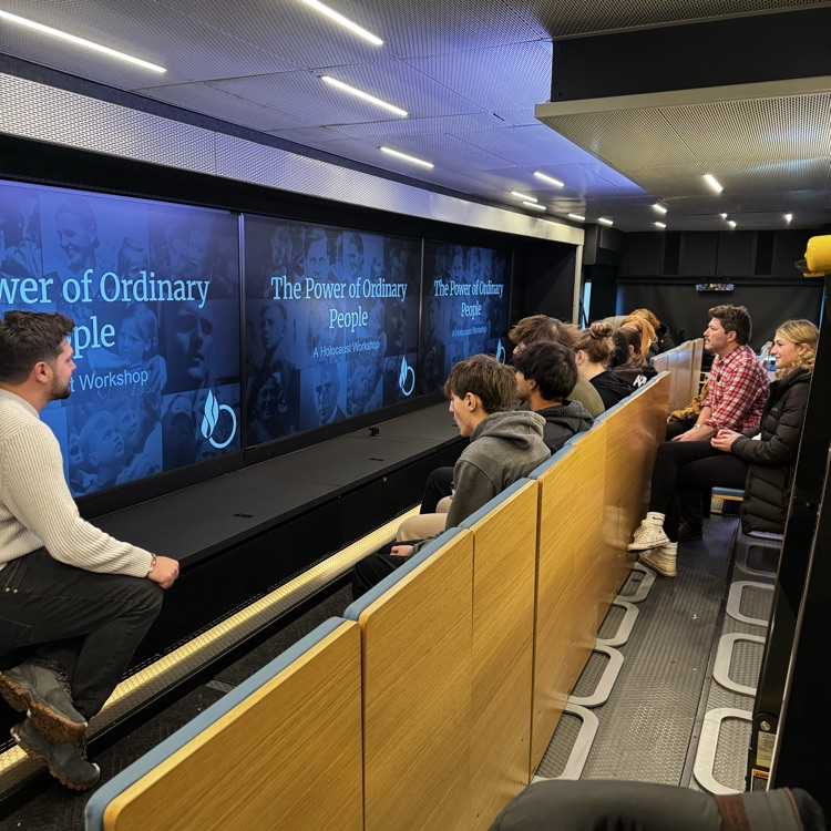 students sitting inside a mobile museum 