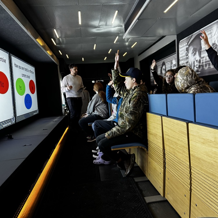 students sitting inside a mobile museum 