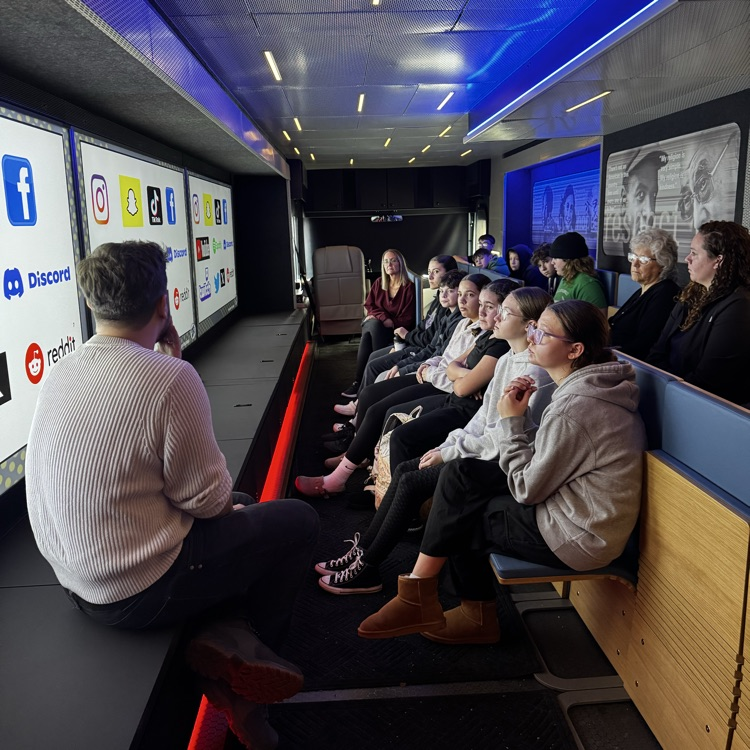 students sitting inside a mobile museum 