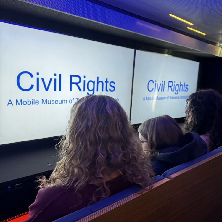 students sitting inside a mobile museum 