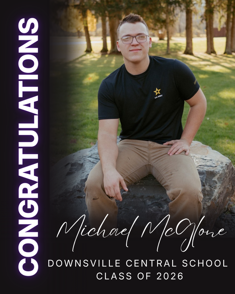 young man sitting on stone for photo