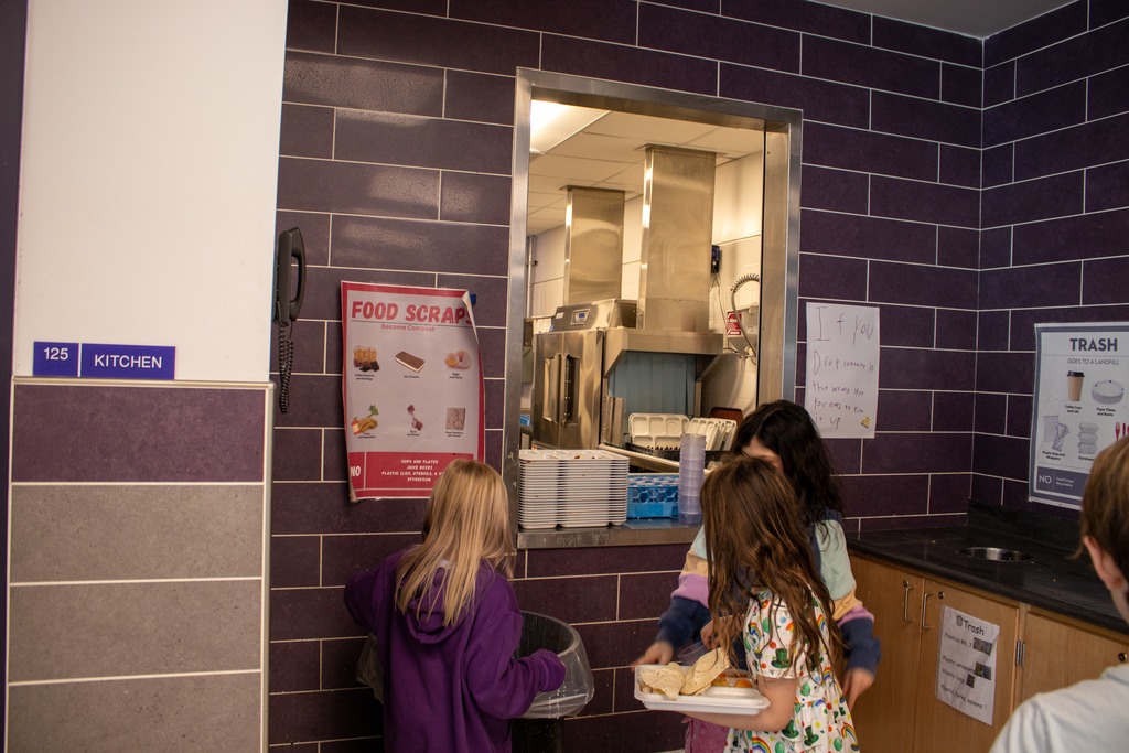 Students at DES dumping their food waste in compost bins