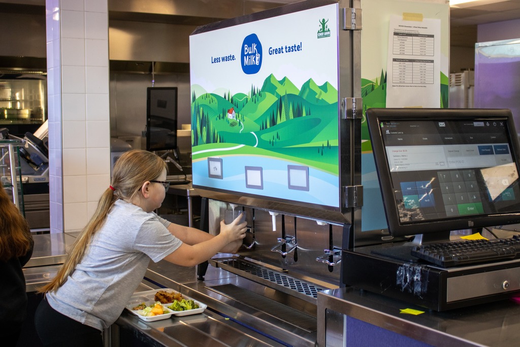 A student at DES fills her glass with bulk milk 