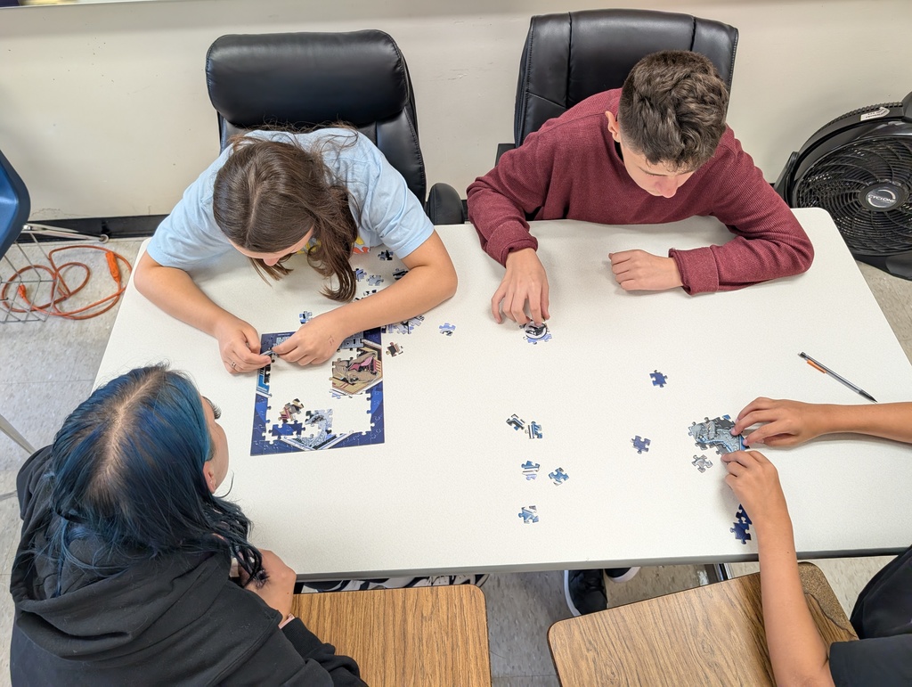small group of students working on a jigsaw puzzle